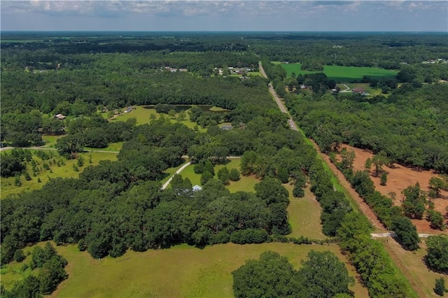 drone / aerial view with a wooded view