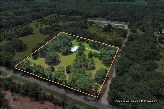 birds eye view of property with a forest view and a rural view