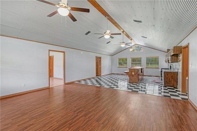 unfurnished living room with ceiling fan, vaulted ceiling, and light hardwood / wood-style flooring