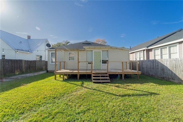 back of house with a lawn and a wooden deck