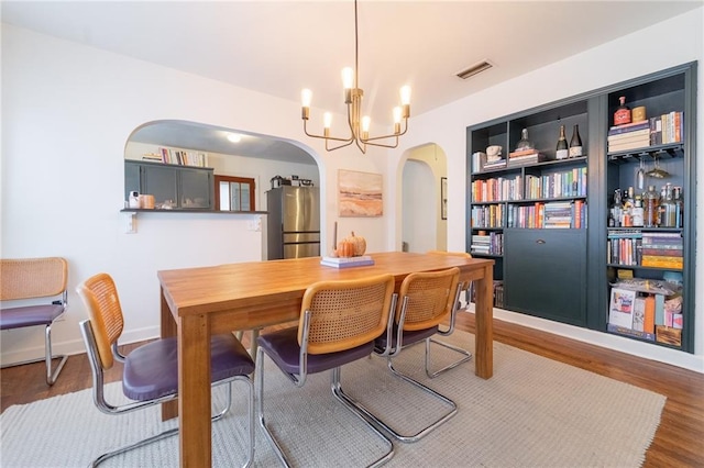 dining room featuring a chandelier and dark hardwood / wood-style flooring