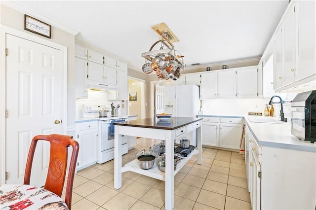 kitchen featuring sink, hanging light fixtures, extractor fan, white appliances, and white cabinets