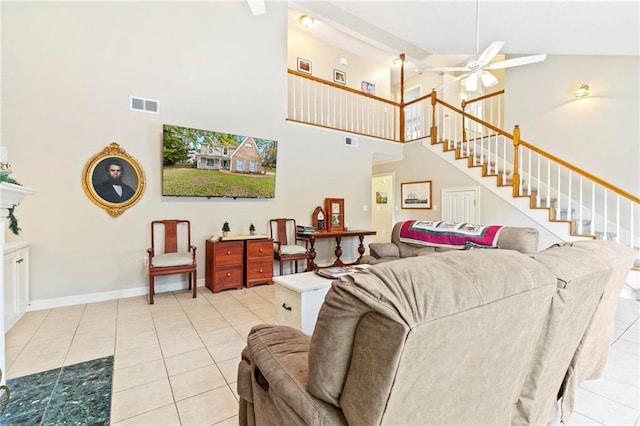 living room featuring ceiling fan, high vaulted ceiling, and light tile patterned floors