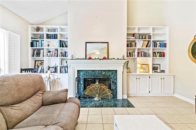 sitting room with a premium fireplace, light tile patterned floors, and lofted ceiling