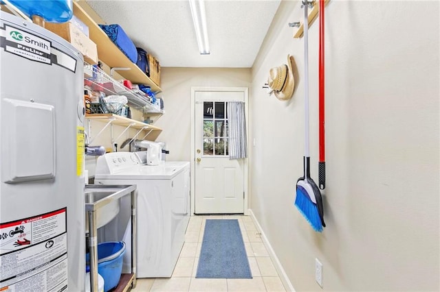 clothes washing area featuring electric water heater, light tile patterned flooring, independent washer and dryer, and a textured ceiling