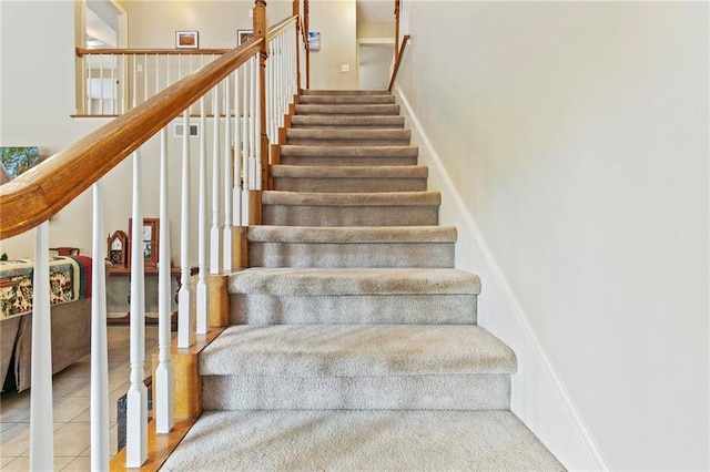 stairs featuring tile patterned floors