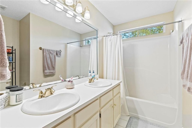 bathroom with tile patterned floors, vanity, and shower / tub combo