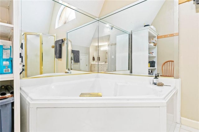 bathroom featuring tile patterned floors, shower with separate bathtub, and vaulted ceiling