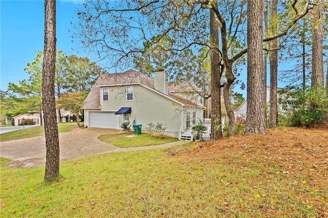 view of side of home with a yard and a garage