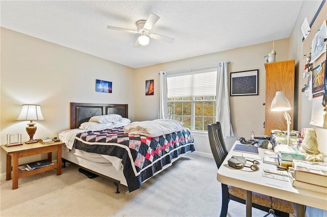 carpeted bedroom with ceiling fan and a textured ceiling