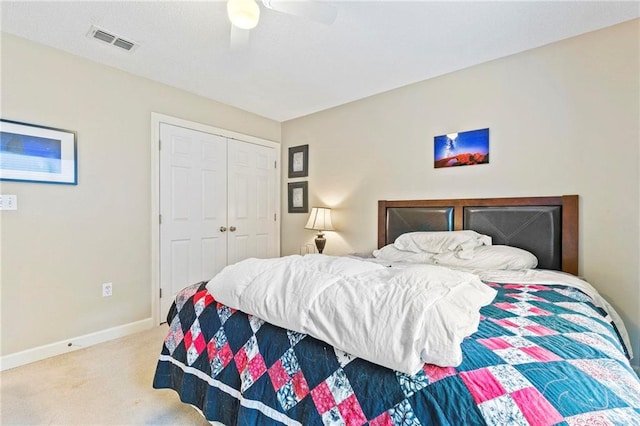 carpeted bedroom featuring ceiling fan and a closet