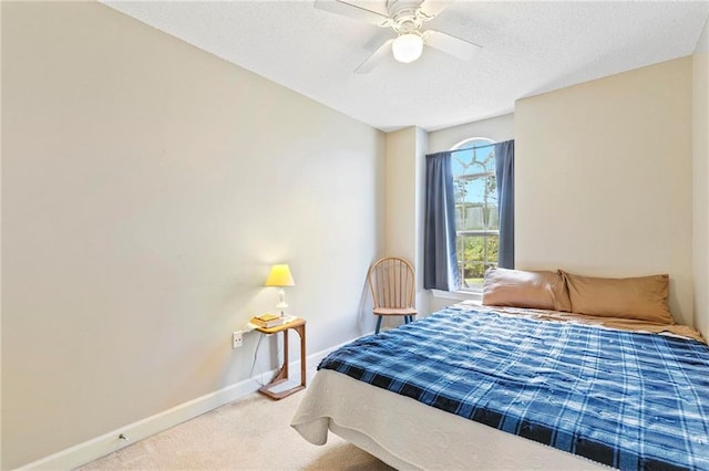 carpeted bedroom with ceiling fan and a textured ceiling