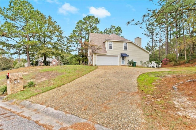 view of front of house featuring a garage and a front yard