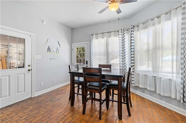 dining space with ceiling fan and a textured ceiling