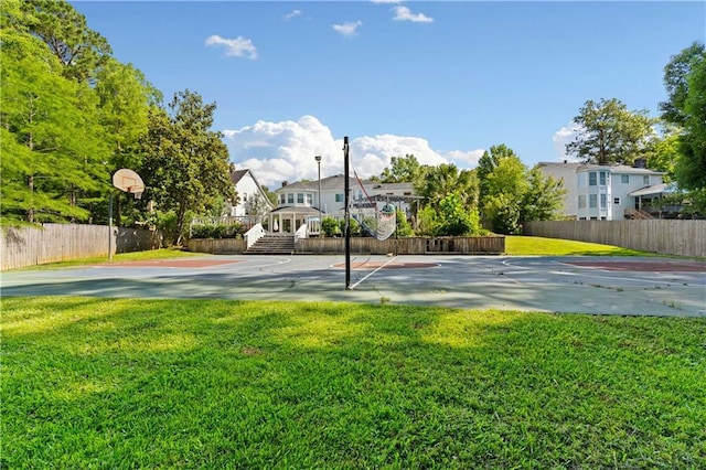 view of basketball court with a lawn