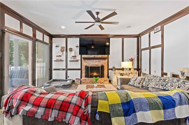 bedroom with a brick fireplace, ornamental molding, and ceiling fan