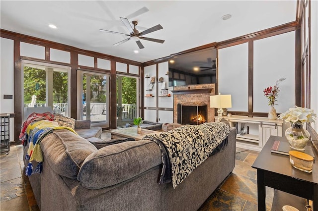 living room featuring tile flooring, ceiling fan, and ornamental molding