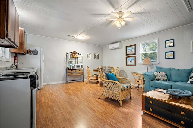 living room featuring light wood-type flooring, a wall unit AC, and ceiling fan