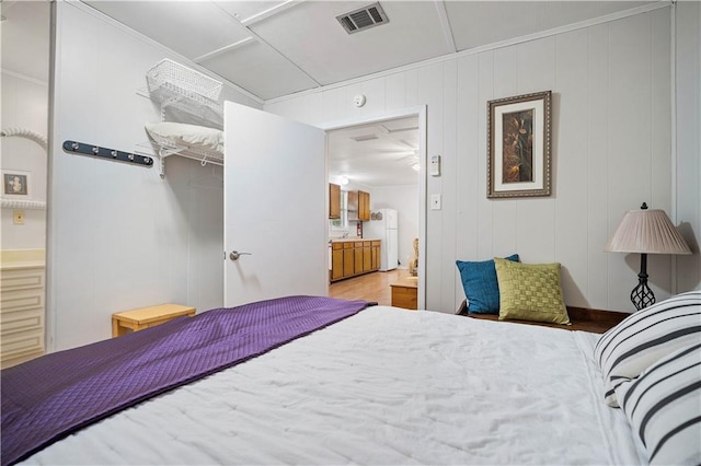 bedroom featuring wood-type flooring and wood walls