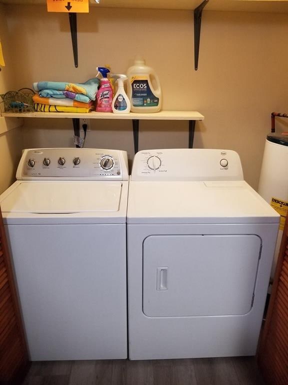 washroom with dark hardwood / wood-style floors and washer and dryer