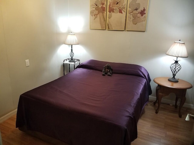 bedroom with wood-type flooring