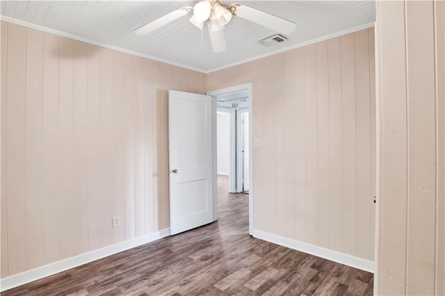 spare room with ceiling fan, dark hardwood / wood-style floors, and crown molding