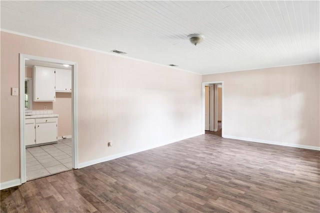 empty room with light wood-type flooring and ornamental molding