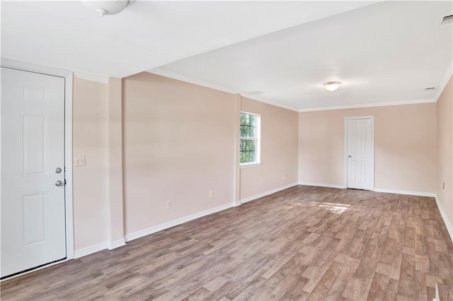 unfurnished room with light wood-type flooring and crown molding