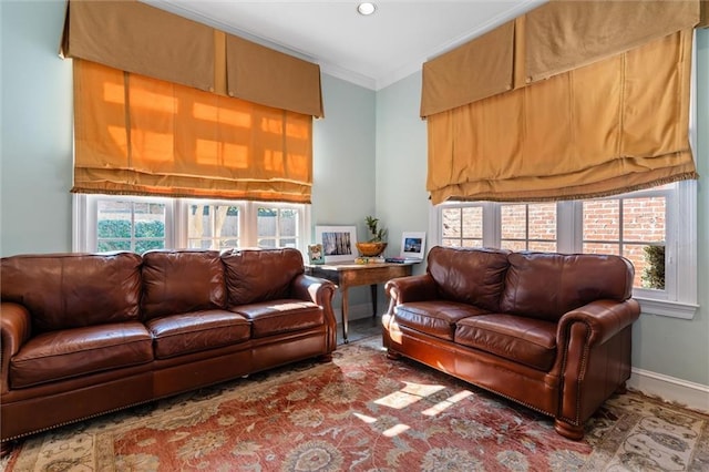 living room with a healthy amount of sunlight and crown molding