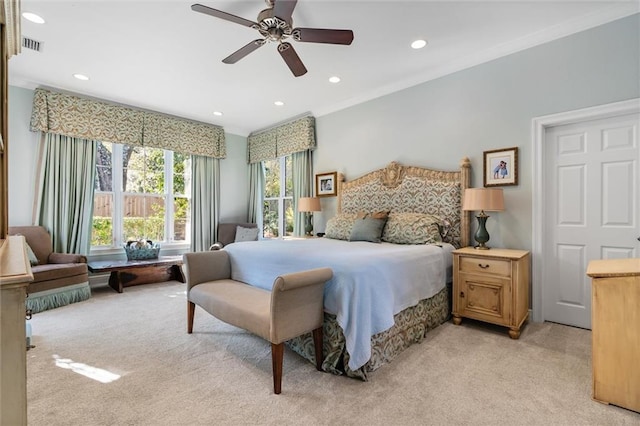 bedroom featuring ceiling fan, crown molding, and light carpet