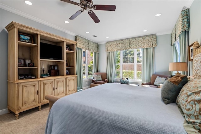 carpeted bedroom featuring ceiling fan and ornamental molding