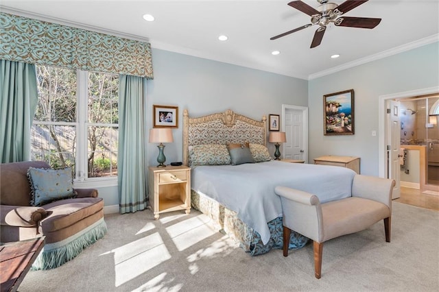 carpeted bedroom featuring ensuite bathroom, ceiling fan, and crown molding