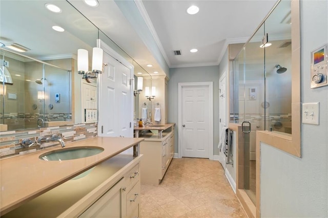 bathroom featuring tile patterned floors, vanity, a shower with shower door, and ornamental molding