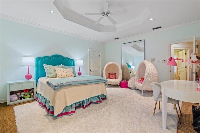 carpeted bedroom featuring a raised ceiling, ceiling fan, and ornamental molding