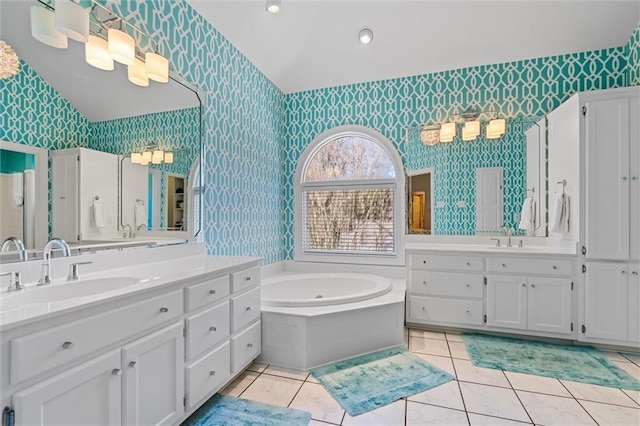 bathroom featuring vanity, tile patterned floors, and a tub