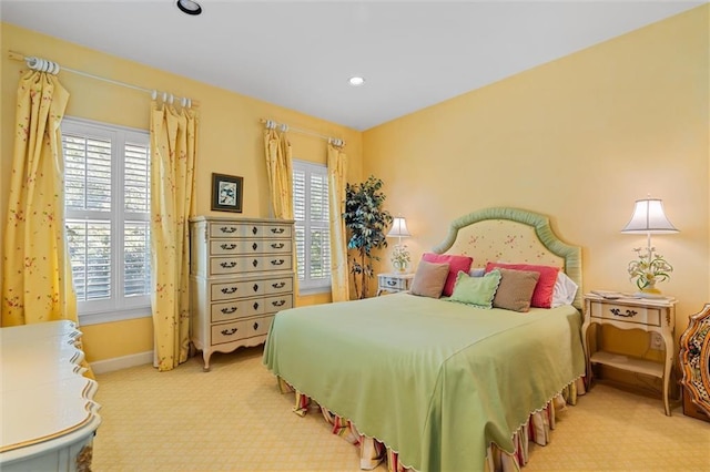 carpeted bedroom featuring multiple windows