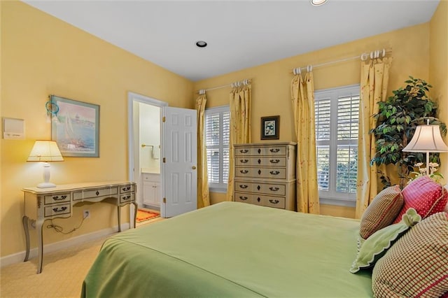 carpeted bedroom featuring connected bathroom