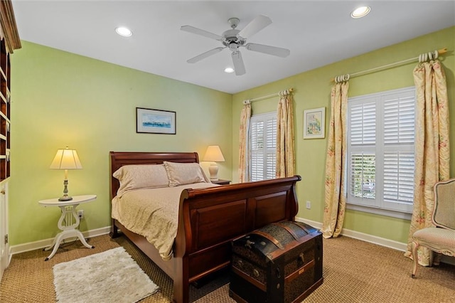 carpeted bedroom with multiple windows and ceiling fan