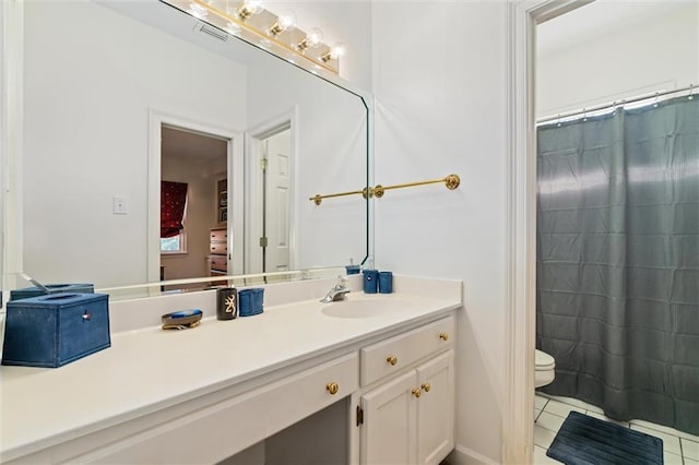 bathroom featuring tile patterned flooring, vanity, and toilet