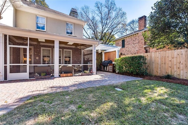 rear view of house with a lawn, a patio area, and ceiling fan