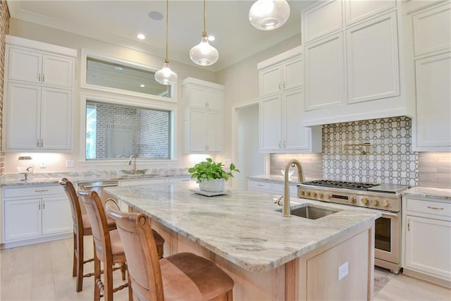 8529 Crepe Myrtle Ct, Mobile, AL 36619 - kitchen with an island with sink, white cabinets, tasteful backsplash, a sink, and stainless steel appliances