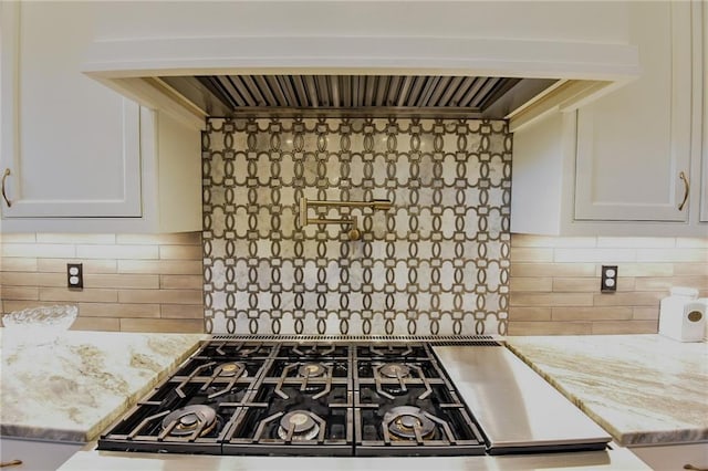 8529 Crepe Myrtle Ct, Mobile, AL 36619 - kitchen featuring light stone counters, white cabinetry, premium range hood, and tasteful backsplash