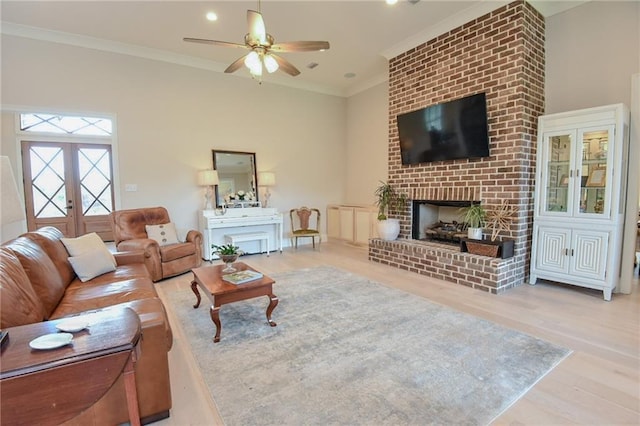 8529 Crepe Myrtle Ct, Mobile, AL 36619 - living area with ornamental molding, wood finished floors, a fireplace, french doors, and a ceiling fan