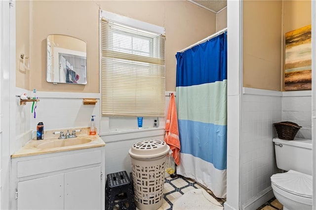201 Catherine St S, Mobile, AL 36604 - full bathroom with vanity, toilet, tile walls, and wainscoting