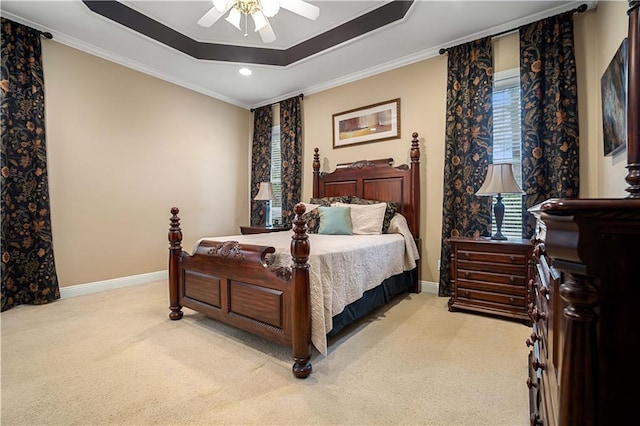 bedroom with light colored carpet, a raised ceiling, ceiling fan, and crown molding