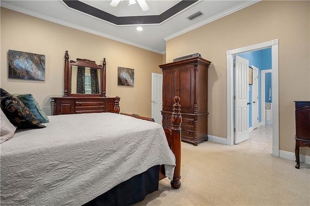 carpeted bedroom featuring ceiling fan, crown molding, connected bathroom, and a tray ceiling