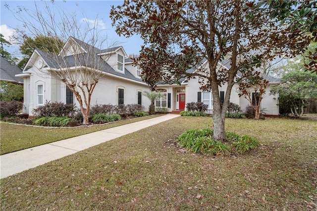 cape cod-style house featuring a front yard