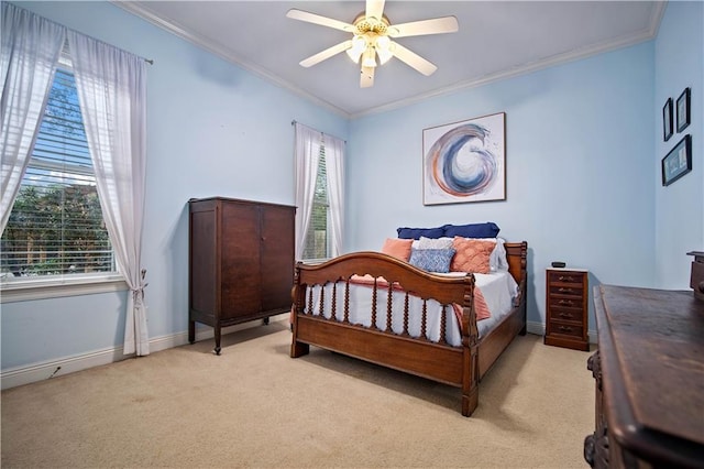 carpeted bedroom with ceiling fan and crown molding