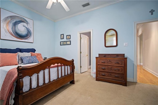 carpeted bedroom featuring ceiling fan and crown molding