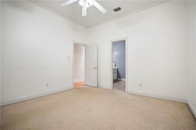 unfurnished bedroom featuring ceiling fan, light colored carpet, and ornamental molding